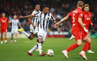 Saint's Keanu Baccus passes through the Aberdeen defence