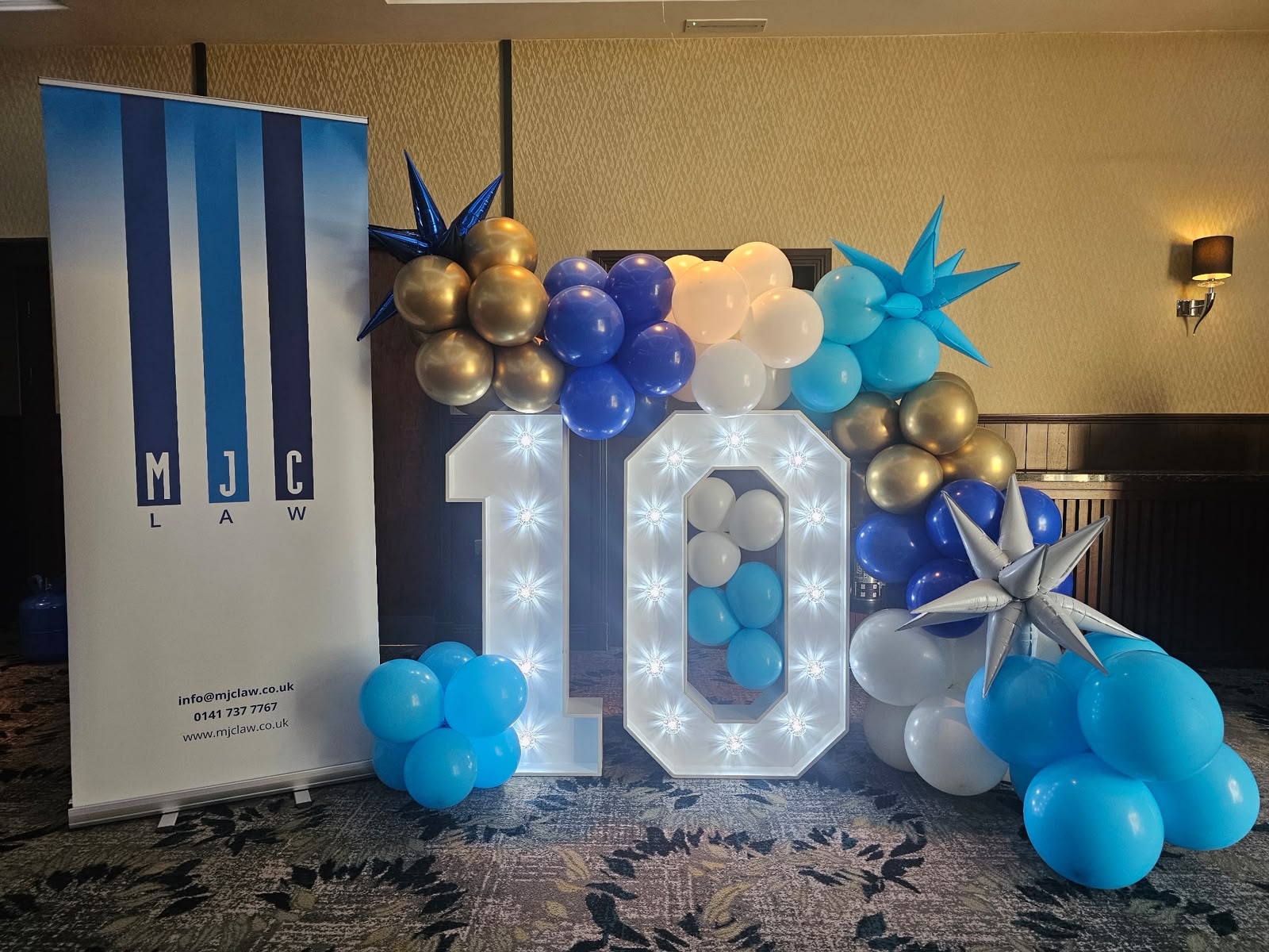 A display marking MJC LAW's 10th anniversary celebration.