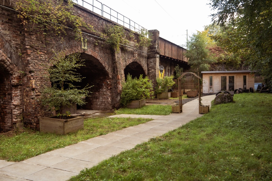 Railway arches, paths and planting in the Finding Your Feet garden