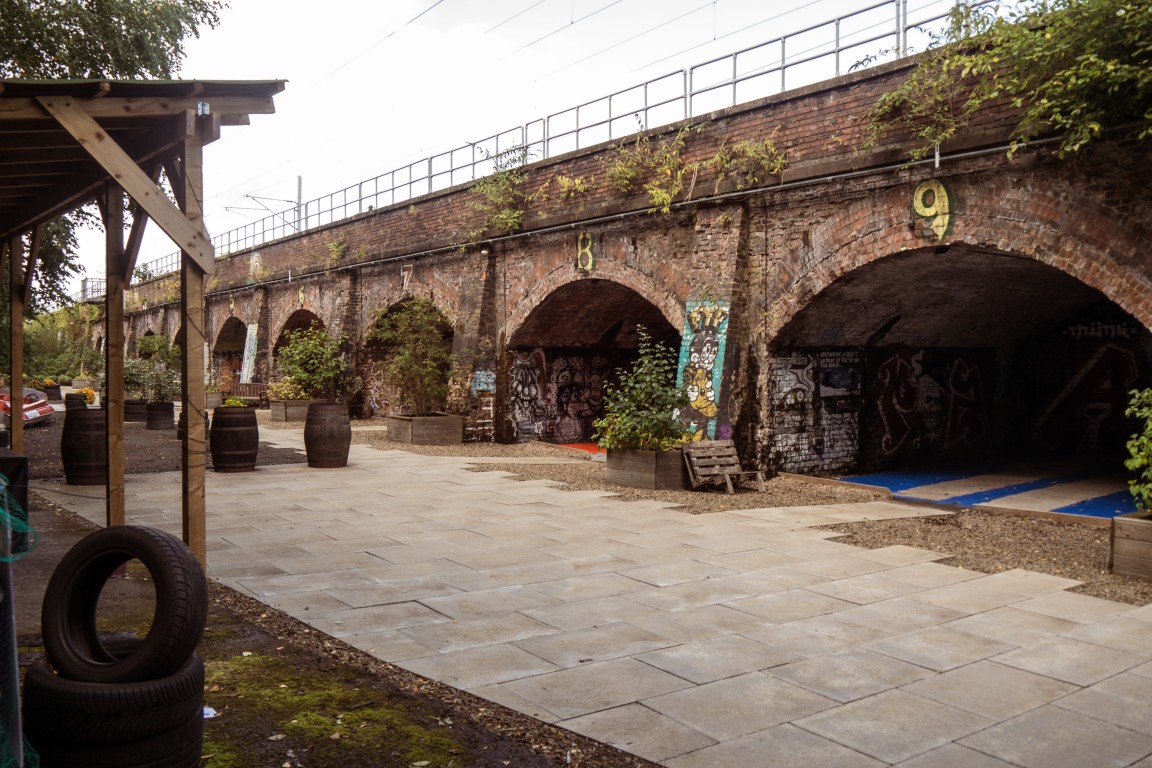 Paved area and railway arches in the Finding Your Feet garden