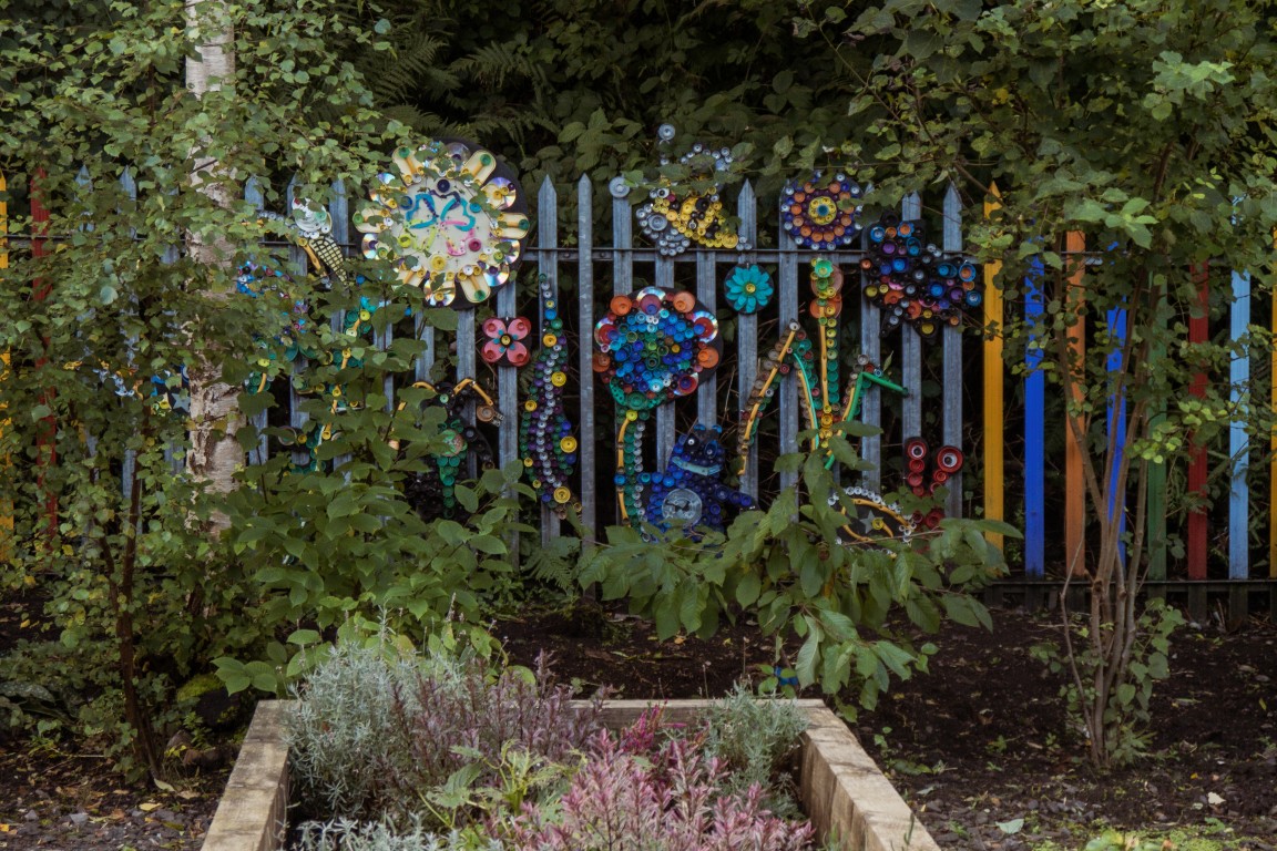 Colourful decorations on a fence in the garden