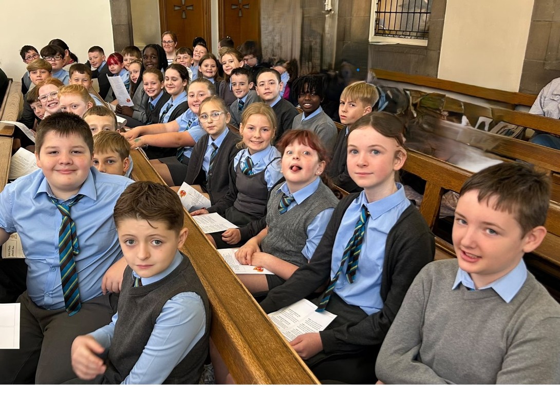 St John Bosco Primary pupils seated in church for the Pilgrims in the Park Mass