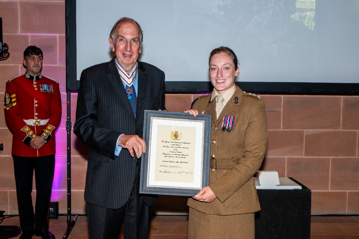 Captain Amy MacDonald receives her certificate from Colonel Peter McCarthy