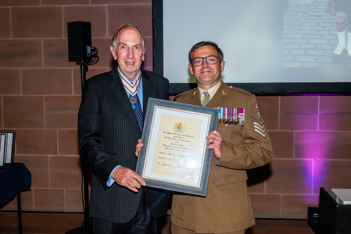 Staff Sergeant James McGowan receives his certificate from Colonel Peter McCarthy