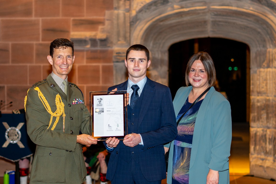 Fiona Macaulay and Ewan O'Donnell collect NHS 24's Silver Award from Brigadier Andy Muddiman